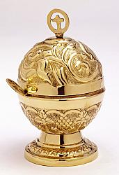 Ornate brass incense holder with spoon